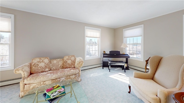 sitting room with baseboard heating, ornamental molding, and carpet