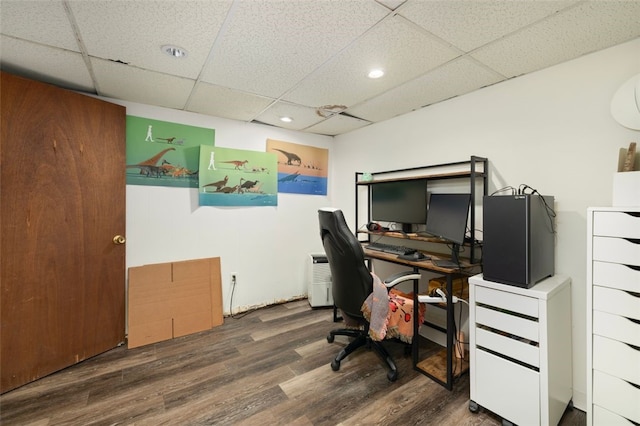 office area with recessed lighting, a paneled ceiling, and wood finished floors