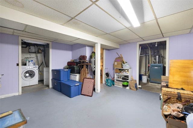 finished below grade area with washer / dryer and a paneled ceiling