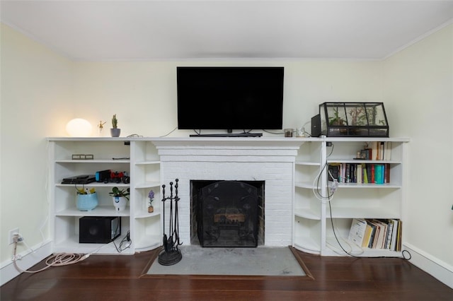 living room with baseboards, ornamental molding, and wood finished floors
