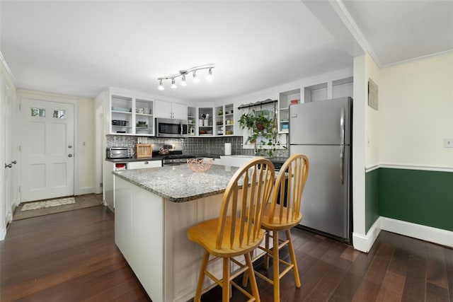 kitchen with open shelves, appliances with stainless steel finishes, a center island, decorative backsplash, and dark wood-style floors