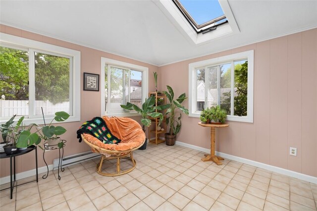 sitting room with a skylight, baseboards, and a baseboard radiator