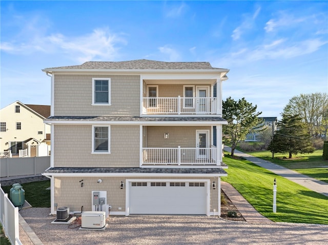 25 Scallop Shell Rd, Narragansett, RI 02882 - view of front of property with fence, a shingled roof, a front lawn, a balcony, and gravel driveway