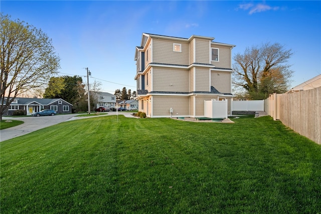 25 Scallop Shell Rd, Narragansett, RI 02882 - back of house featuring fence, a yard, and a residential view