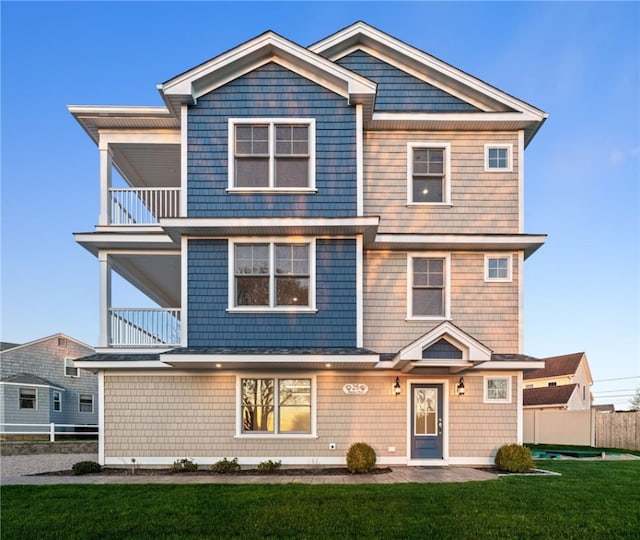25 Scallop Shell Rd, Narragansett, RI 02882 - view of front of home featuring a front lawn, fence, and a balcony