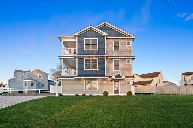 25 Scallop Shell Rd, Narragansett, RI 02882 - view of front of house with a front lawn, fence, and a balcony