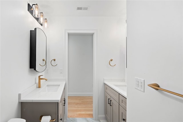 25 Scallop Shell Rd, Narragansett, RI 02882 - bathroom featuring a sink, baseboards, two vanities, wood finished floors, and visible vents