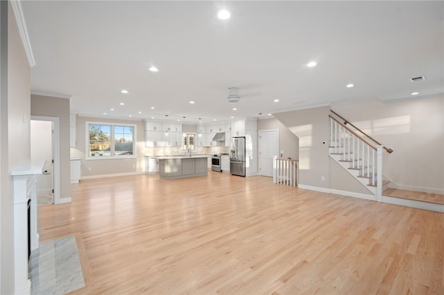 25 Scallop Shell Rd, Narragansett, RI 02882 - unfurnished living room featuring crown molding, a ceiling fan, baseboards, and recessed lighting