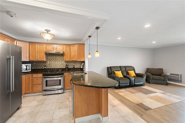 752 Quaker Ln Unit B108, Warwick, RI 02818 - kitchen featuring ornamental molding, a peninsula, under cabinet range hood, a sink, and appliances with stainless steel finishes
