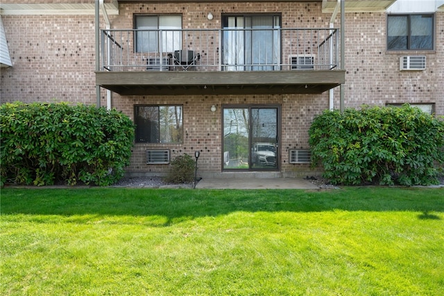 752 Quaker Ln Unit B108, Warwick, RI 02818 - back of house featuring a lawn, brick siding, central AC, and a balcony