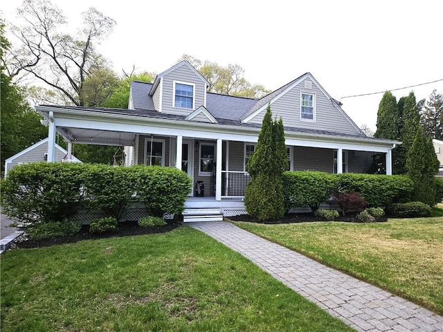 view of front of house featuring covered porch and a front yard