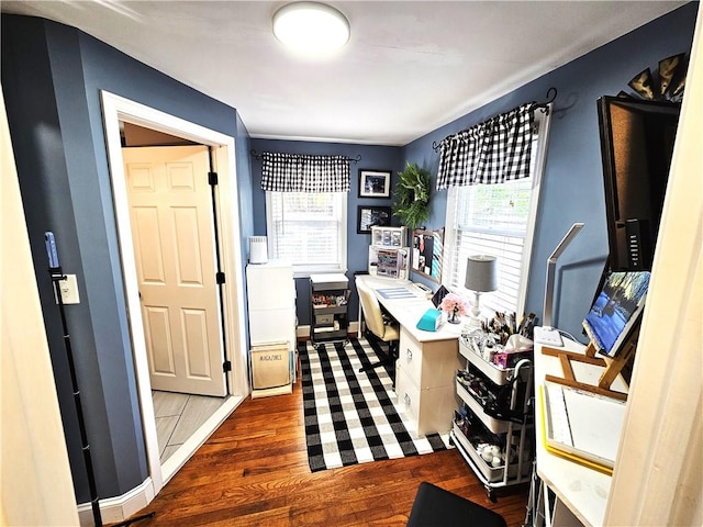 home office with baseboards and wood finished floors