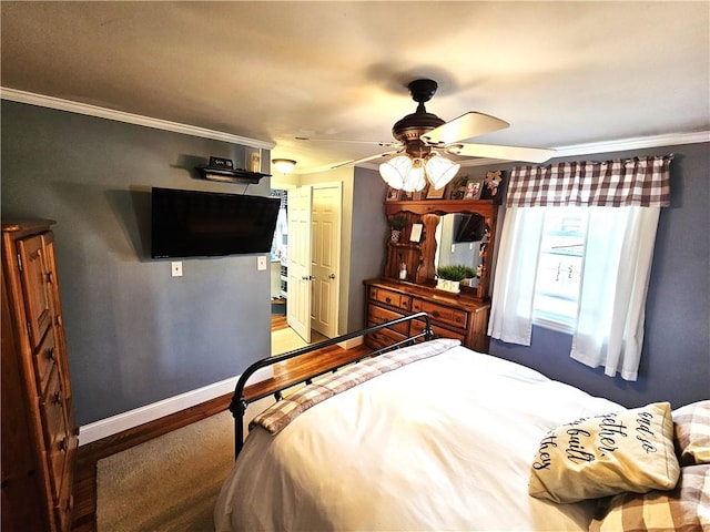 bedroom featuring crown molding, baseboards, ceiling fan, and wood finished floors