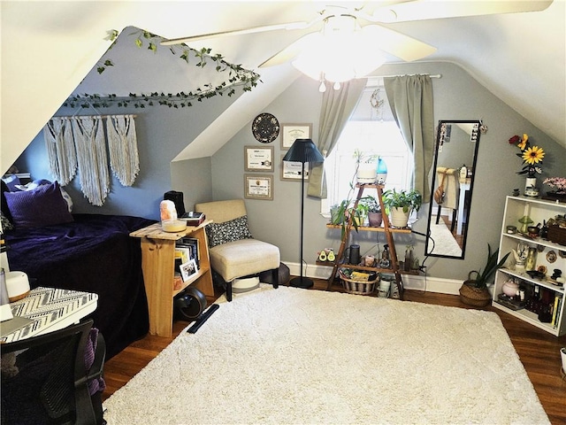 bedroom with baseboards, lofted ceiling, and dark wood-style floors