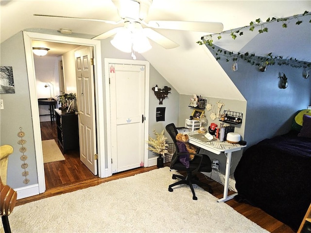 office area with ceiling fan, dark wood finished floors, baseboards, and lofted ceiling