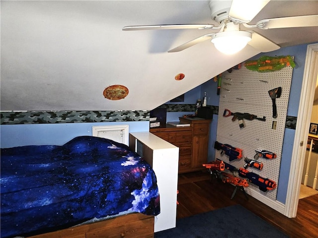 bedroom featuring a ceiling fan, vaulted ceiling, and wood finished floors