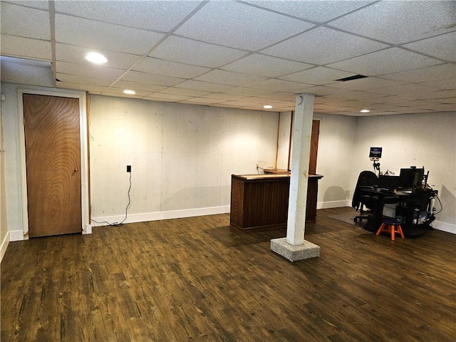 finished basement featuring a paneled ceiling, recessed lighting, baseboards, and wood finished floors