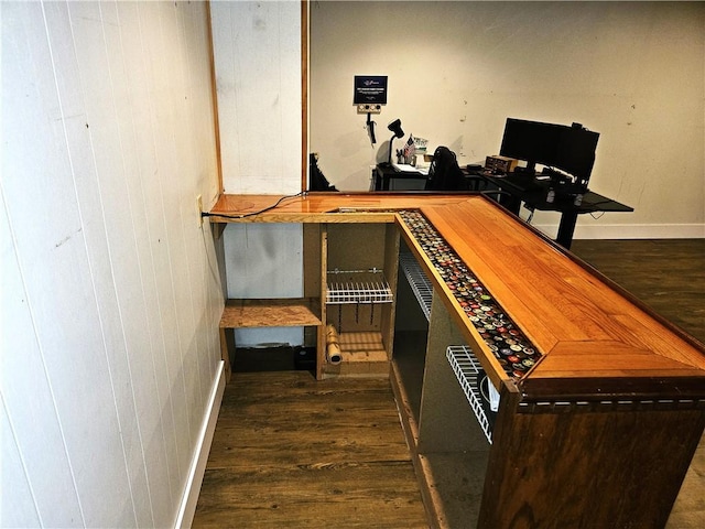 interior space with baseboards and wood finished floors