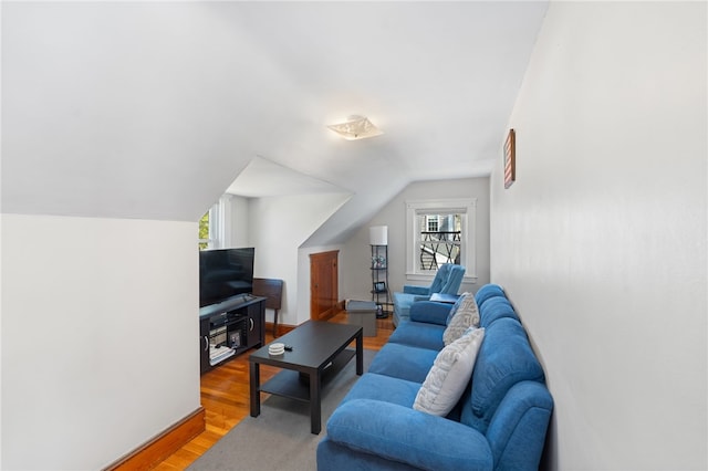 living area featuring lofted ceiling and light wood-style floors