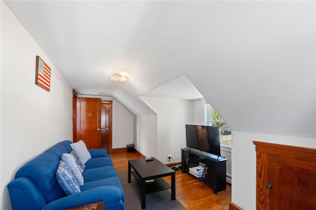 living area featuring wood finished floors and lofted ceiling