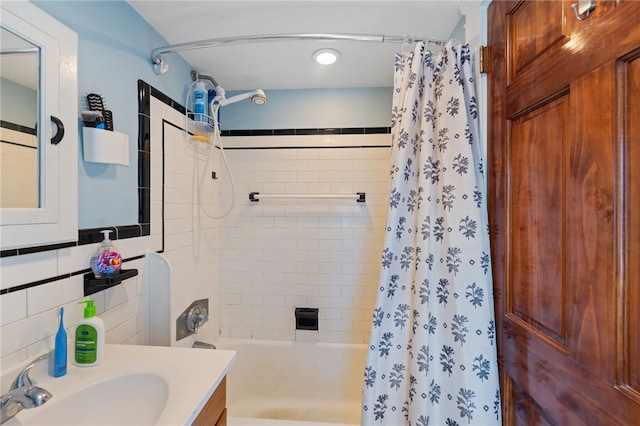 full bath featuring vanity and shower / bath combo with shower curtain