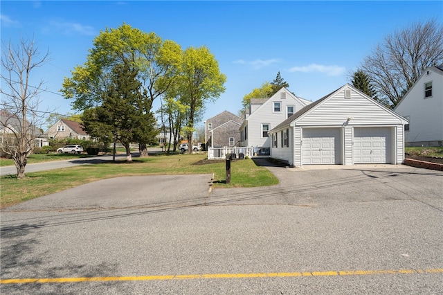 view of front of house featuring a garage, a front yard, and aphalt driveway