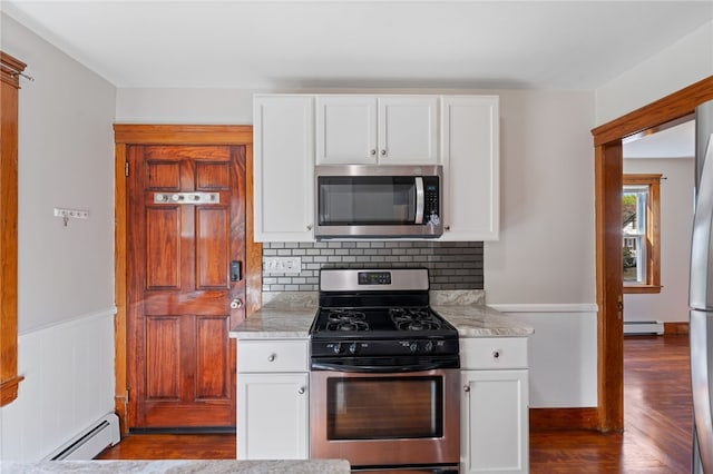 kitchen with backsplash, stainless steel appliances, dark wood finished floors, and a baseboard radiator