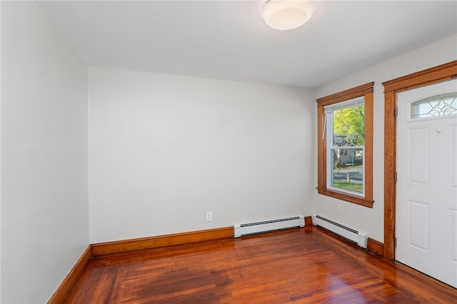 entrance foyer featuring baseboards, a baseboard heating unit, and wood finished floors