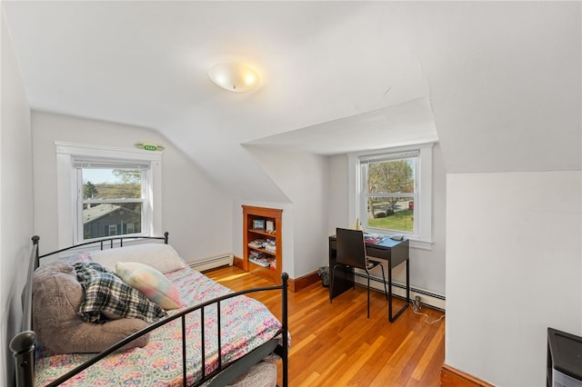 bedroom with light wood-style floors, lofted ceiling, a baseboard heating unit, and multiple windows