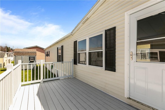 wooden deck with a lawn