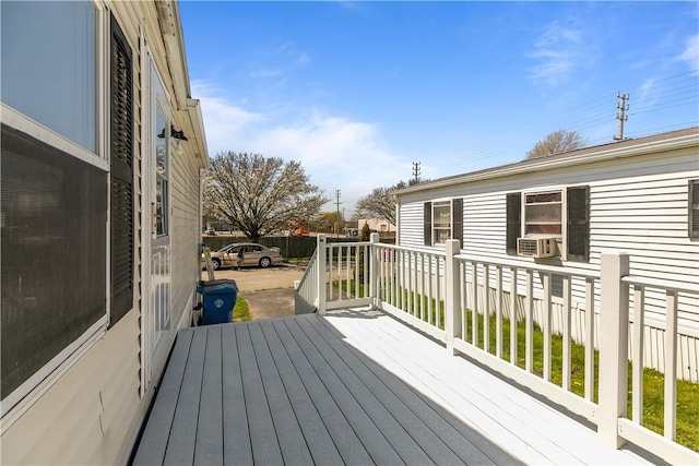 deck featuring fence and cooling unit