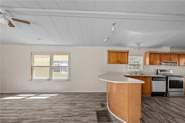 kitchen featuring electric range, brown cabinets, dark wood finished floors, dishwashing machine, and under cabinet range hood