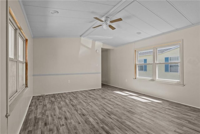 spare room featuring ceiling fan, vaulted ceiling with beams, and wood finished floors