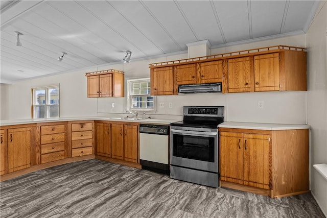 kitchen featuring under cabinet range hood, dishwasher, brown cabinets, and stainless steel range with electric cooktop