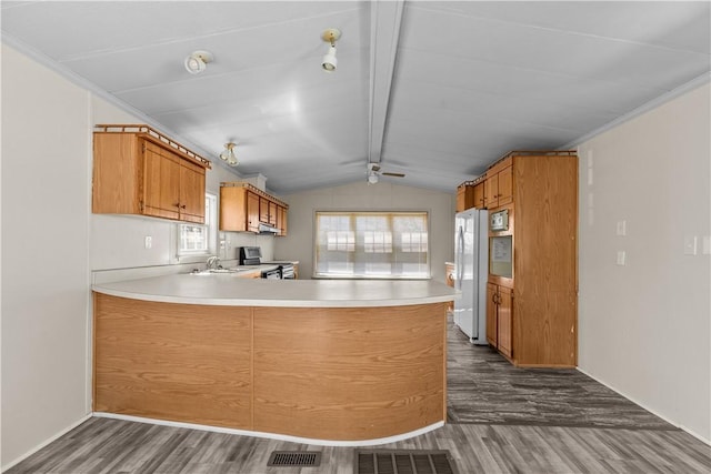 kitchen featuring dark wood-style flooring, electric range, light countertops, freestanding refrigerator, and vaulted ceiling with beams