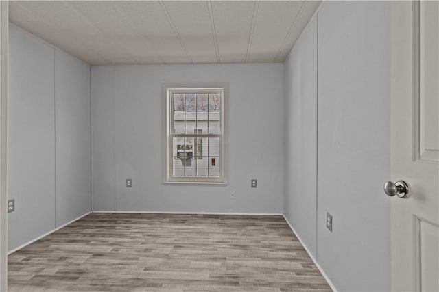 unfurnished room with wood finished floors