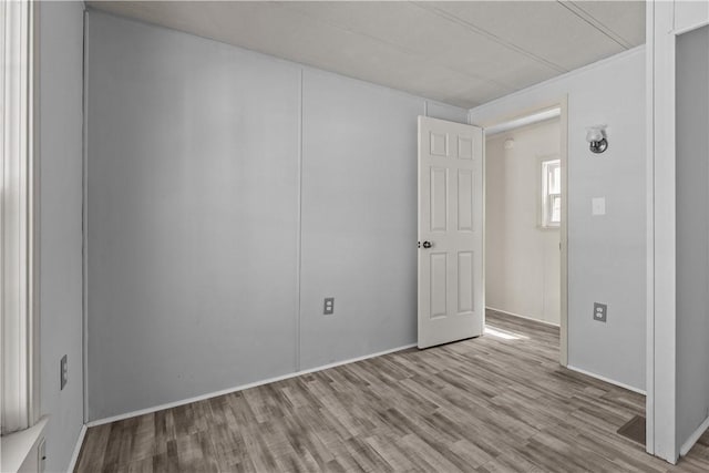 unfurnished room with light wood-type flooring