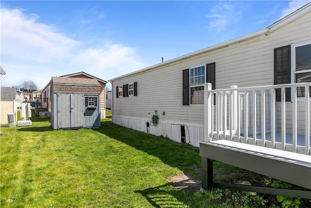 rear view of property with a storage shed, an outdoor structure, a yard, and a wooden deck