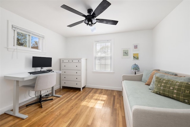 bedroom with baseboards, light wood finished floors, ceiling fan, and multiple windows