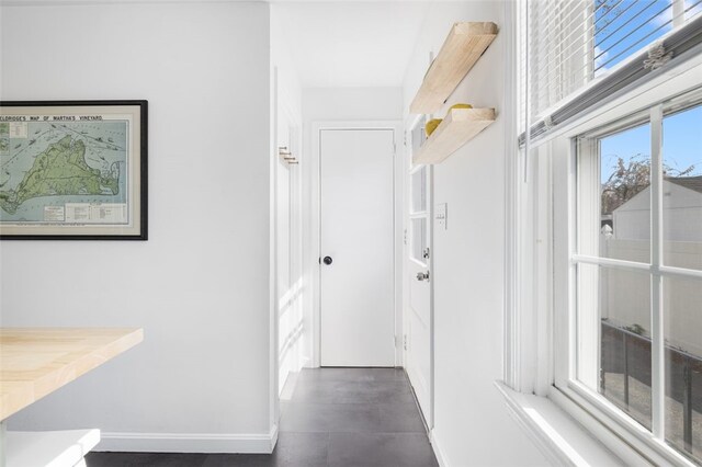 corridor featuring baseboards