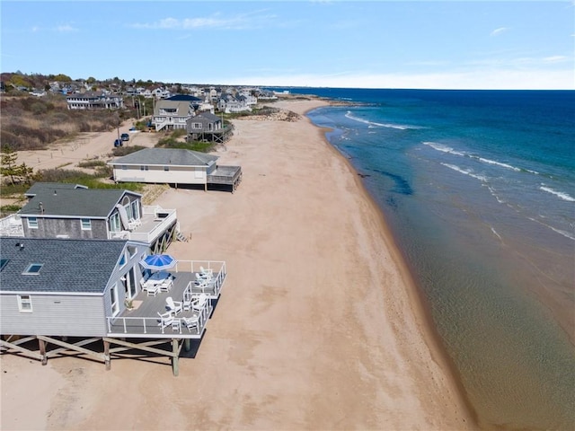drone / aerial view with a beach view and a water view