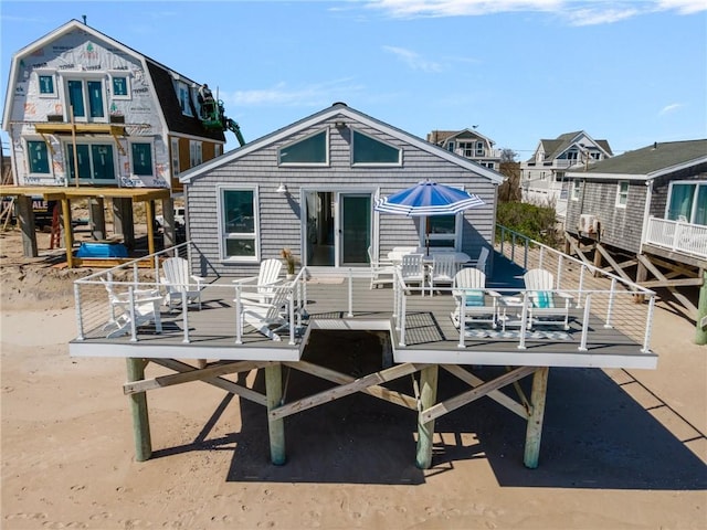 rear view of property featuring a deck