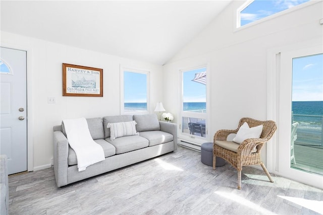 living room featuring plenty of natural light, lofted ceiling, and wood finished floors
