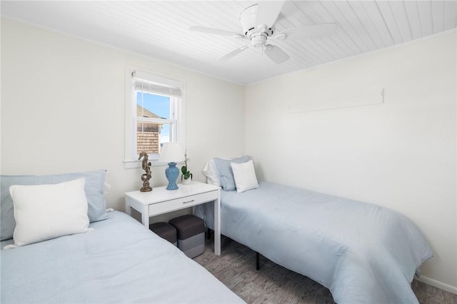 bedroom with a ceiling fan, wood finished floors, and wooden ceiling