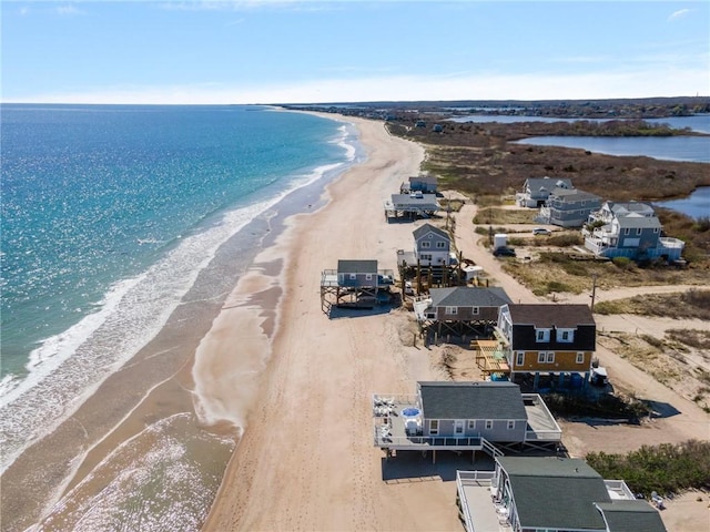 birds eye view of property featuring a beach view and a water view