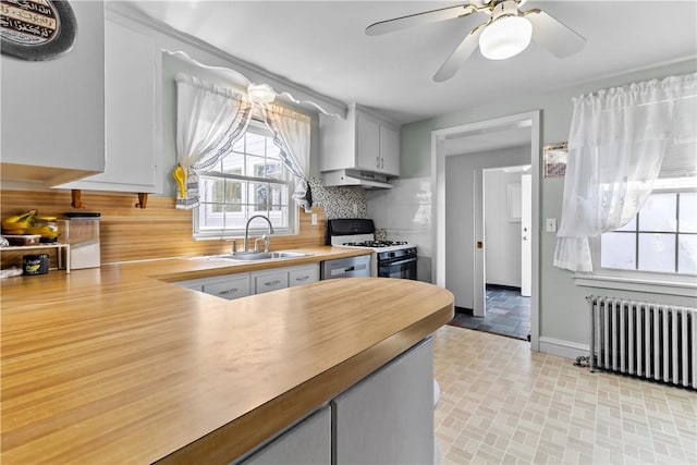 15 Broadmoor Rd, Cranston, RI 02910 - kitchen with decorative backsplash, radiator, white gas stove, under cabinet range hood, and a sink
