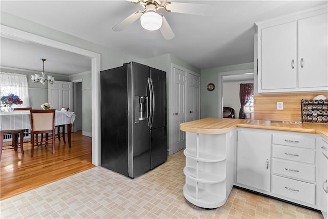 15 Broadmoor Rd, Cranston, RI 02910 - kitchen featuring stainless steel refrigerator with ice dispenser, light countertops, ceiling fan with notable chandelier, and white cabinets