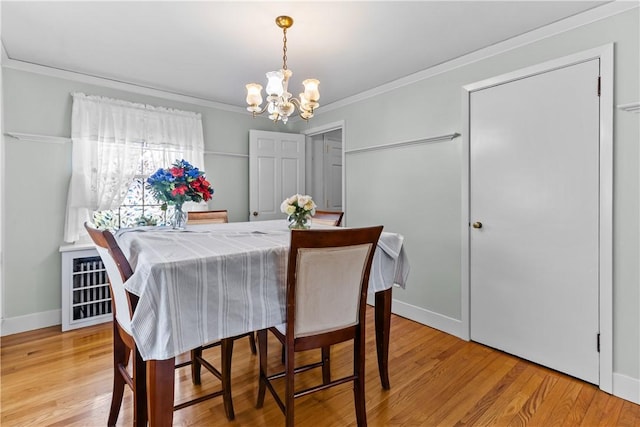 15 Broadmoor Rd, Cranston, RI 02910 - dining area with an inviting chandelier, ornamental molding, and light wood finished floors