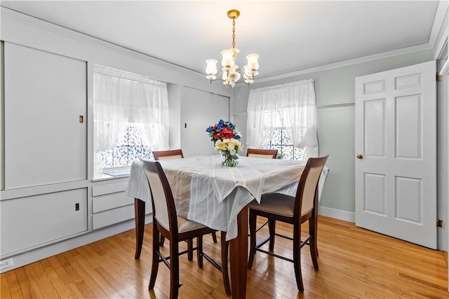 15 Broadmoor Rd, Cranston, RI 02910 - dining space with crown molding, baseboards, light wood finished floors, and a notable chandelier