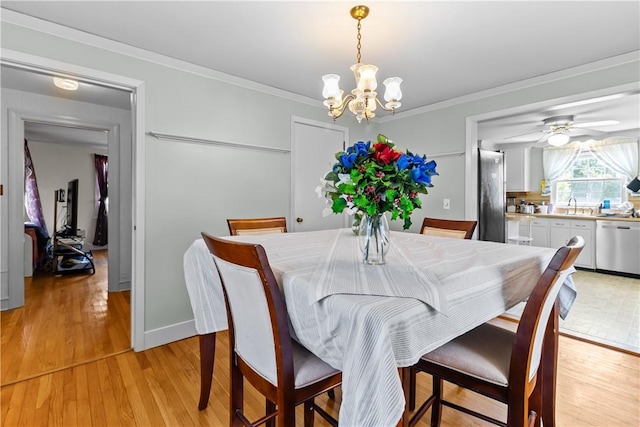 15 Broadmoor Rd, Cranston, RI 02910 - dining room with crown molding, baseboards, ceiling fan with notable chandelier, and light wood-style floors